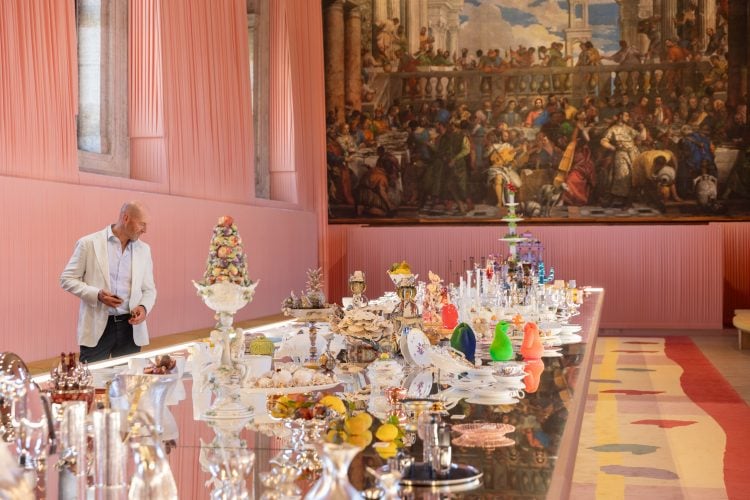 IWC Chief Design Officer Christian Knoop looking at various artifacts on a long table