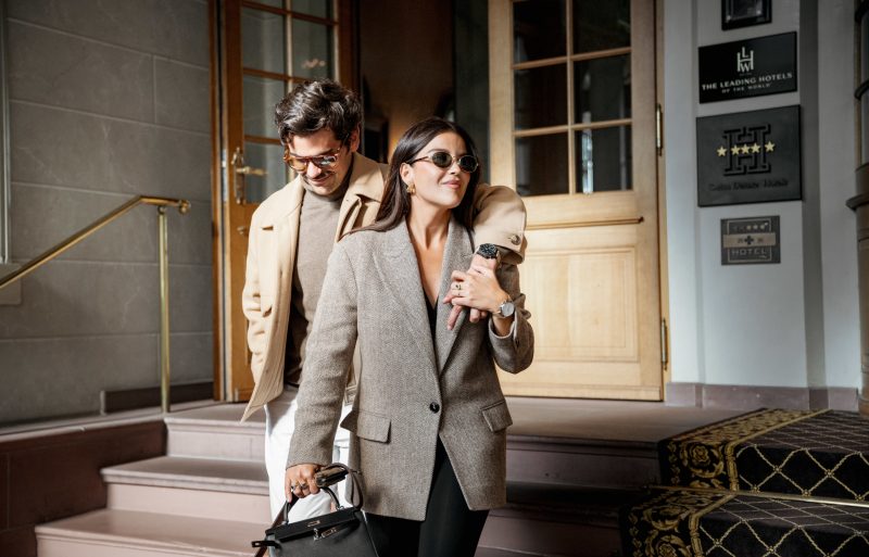 A couple in beige jackets leaving a hotel ,A couple in beige jackets leaving a hotel