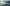 Long shot of a Cable-Car above the clouds with mountains in the background.