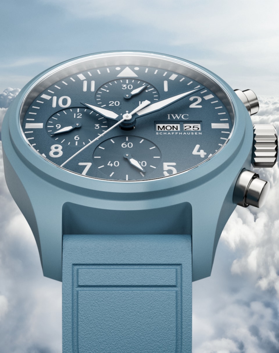 Pilot's Watch Chronograph 41 with light blue dial, light blue rubber strap and stainless steel case on blue misty background.