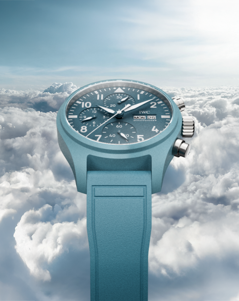 Pilot's Watch Chronograph 41 with light blue dial, light blue rubber strap and stainless steel case on blue misty background.