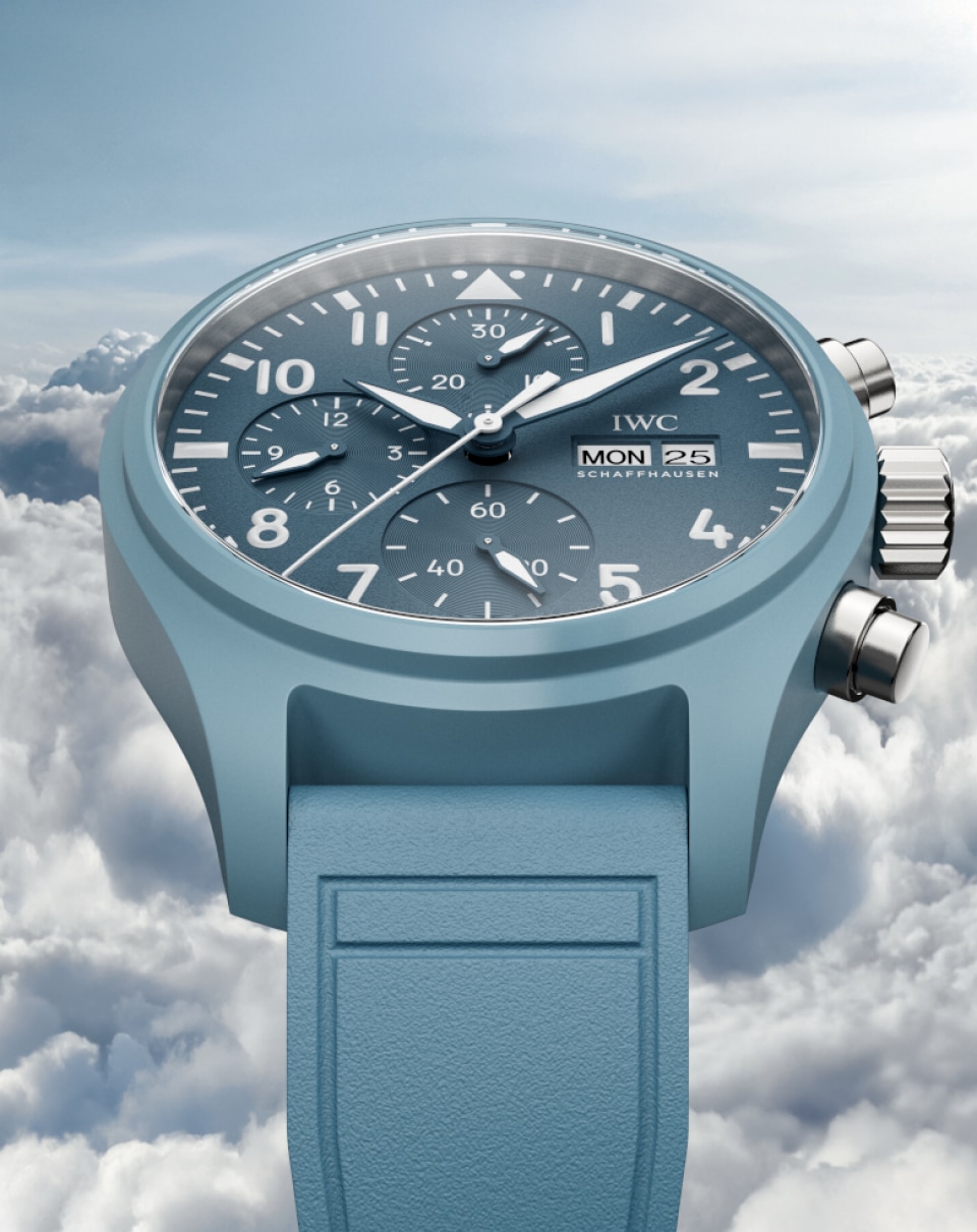 Pilot's Watch Chronograph 41 with light blue dial, light blue rubber strap and stainless steel case on blue misty background.