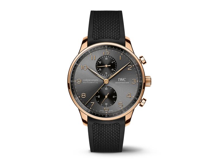 The Portugieser Chronograph in 18-carat 5N gold with a black dial (Ref. IW371610) on a black rubber strap.